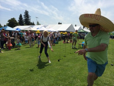 LVLIfe sponsoring realtor Jim Lanctot, looking dashing in a sombrero, coaches a Masters category runner through the obstacle course.