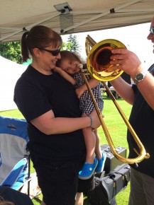 This Black Bear Band niece is getting an early intro to the art of the trombone from Uncle Jeff Seddon, a member of the band's 'Impalers' t-bone section.